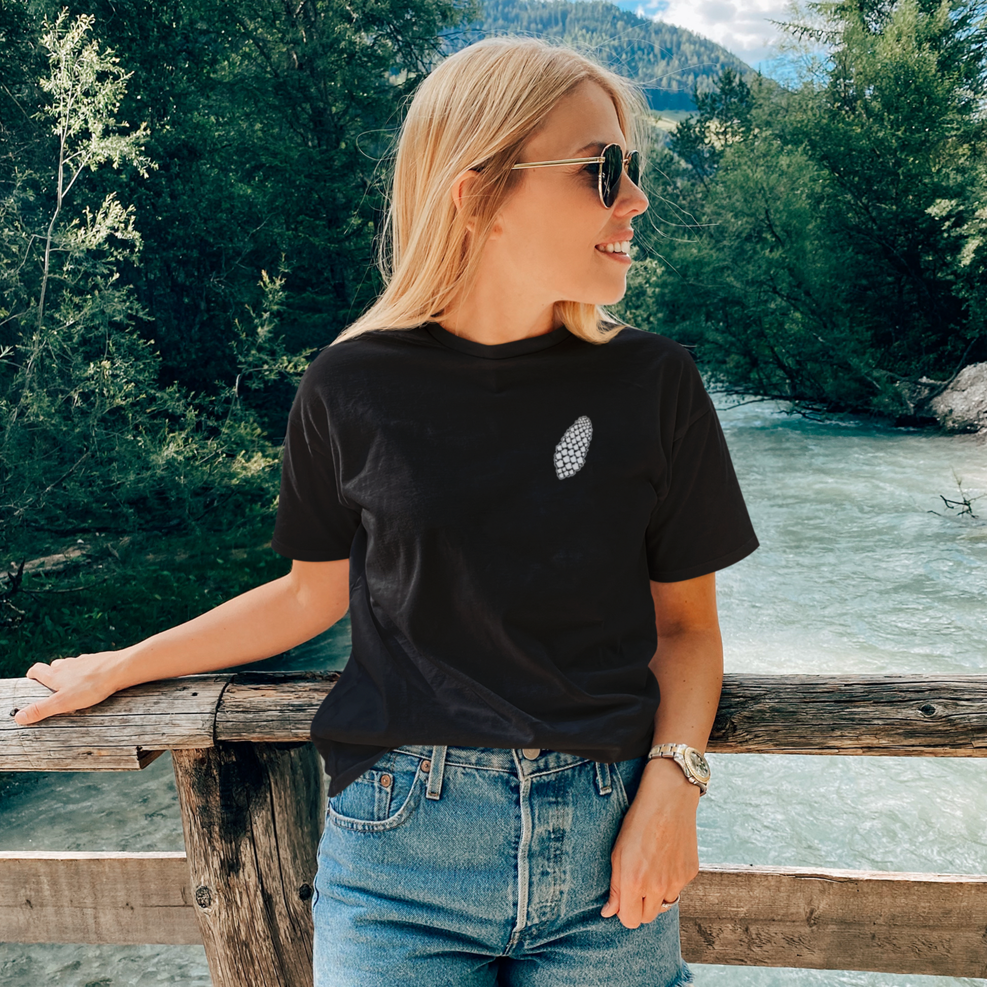 Blonde woman wearing black pinecone T-Shirt