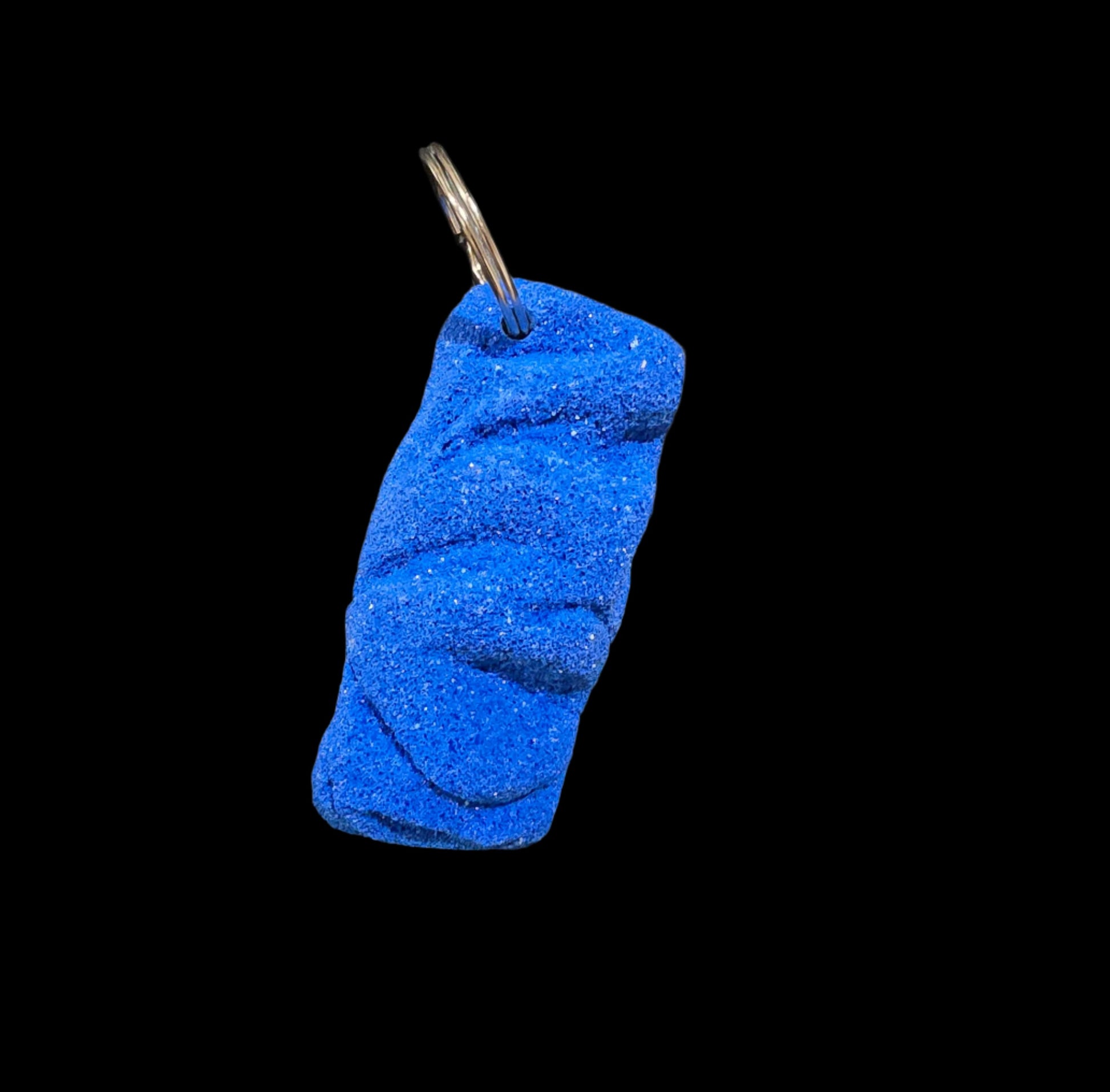 Blue colored eroded shape climbing hold keychain
