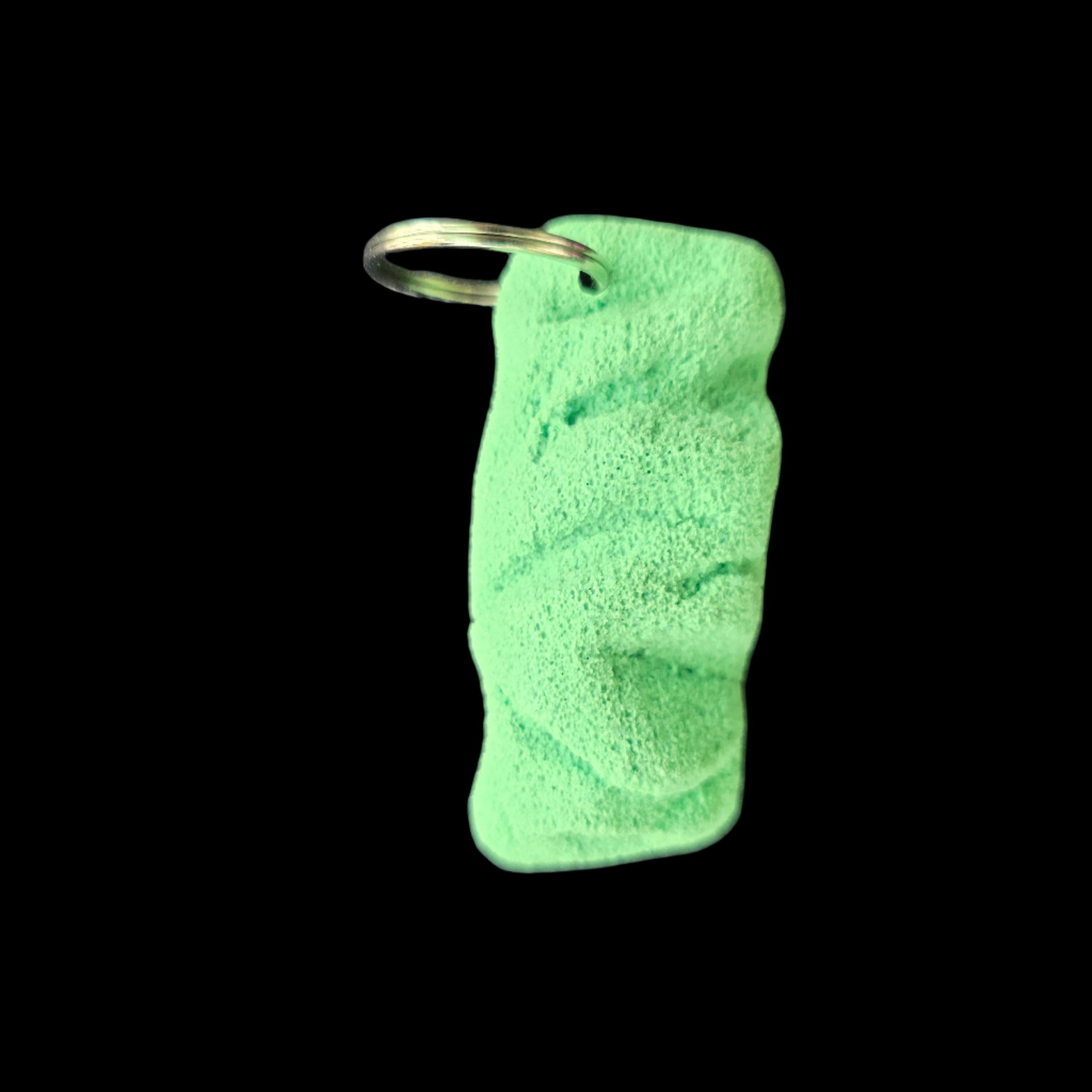 Green colored eroded shape climbing hold keychain