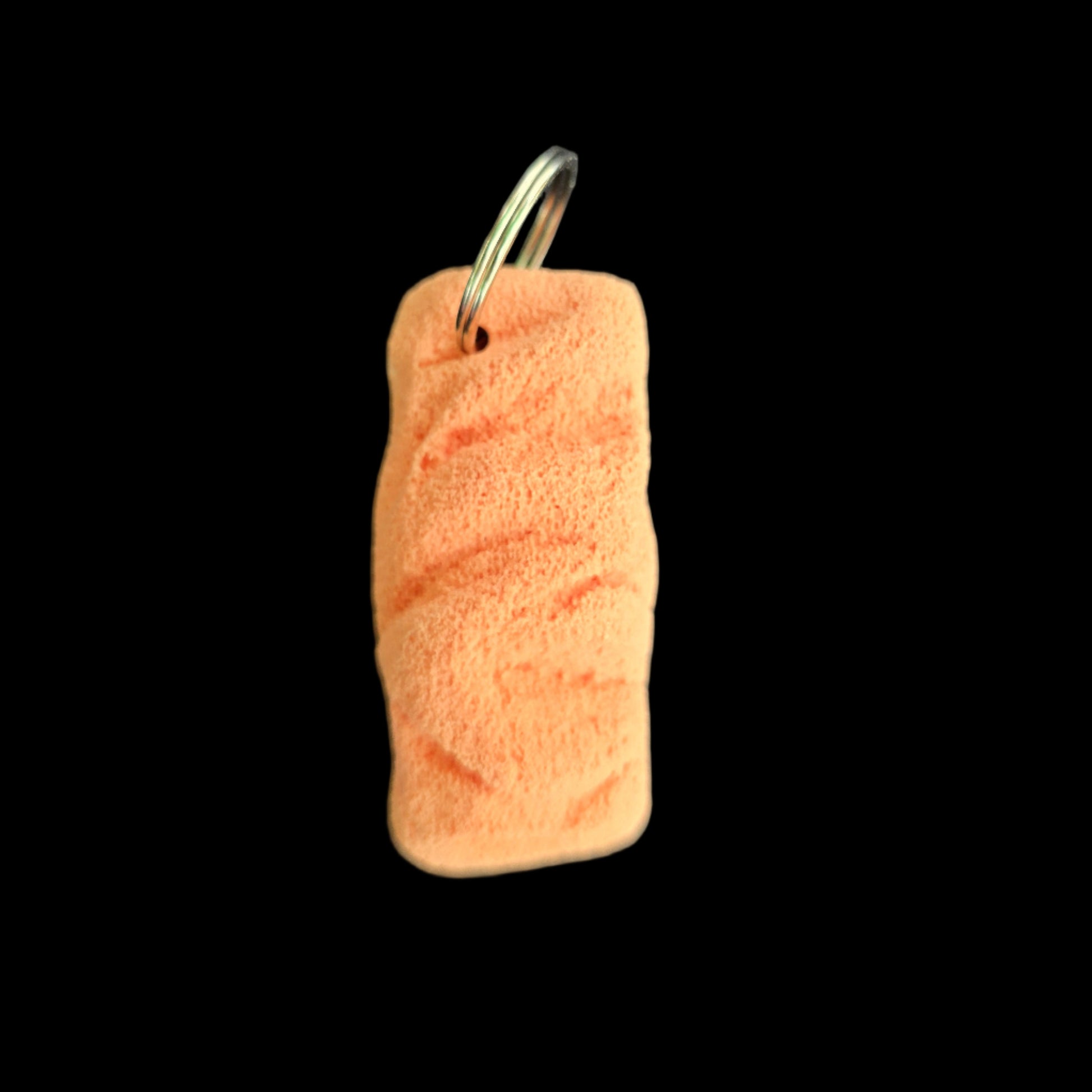 Orange colored eroded shape climbing hold keychain