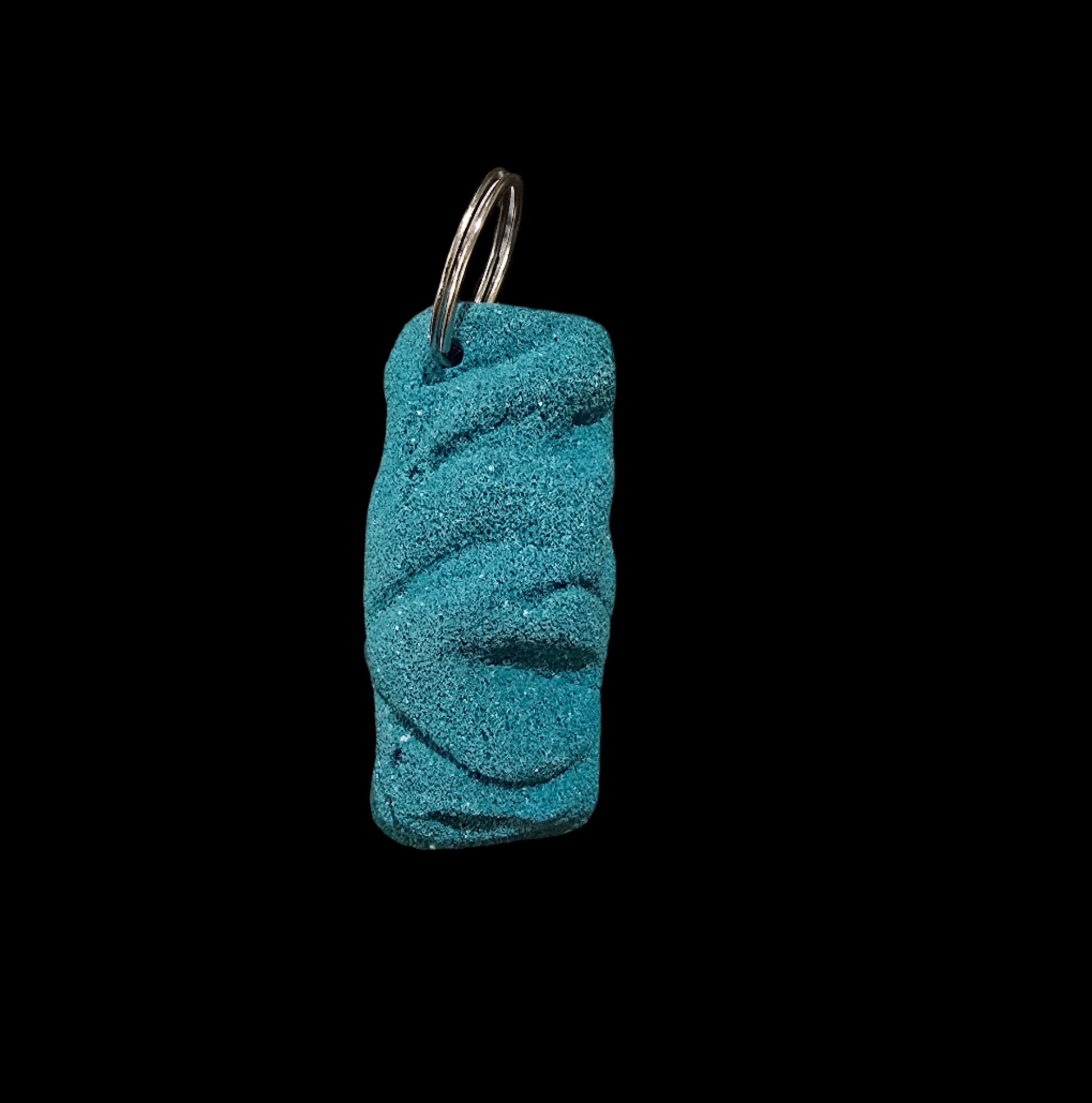 Teal colored eroded shape climbing hold keychain