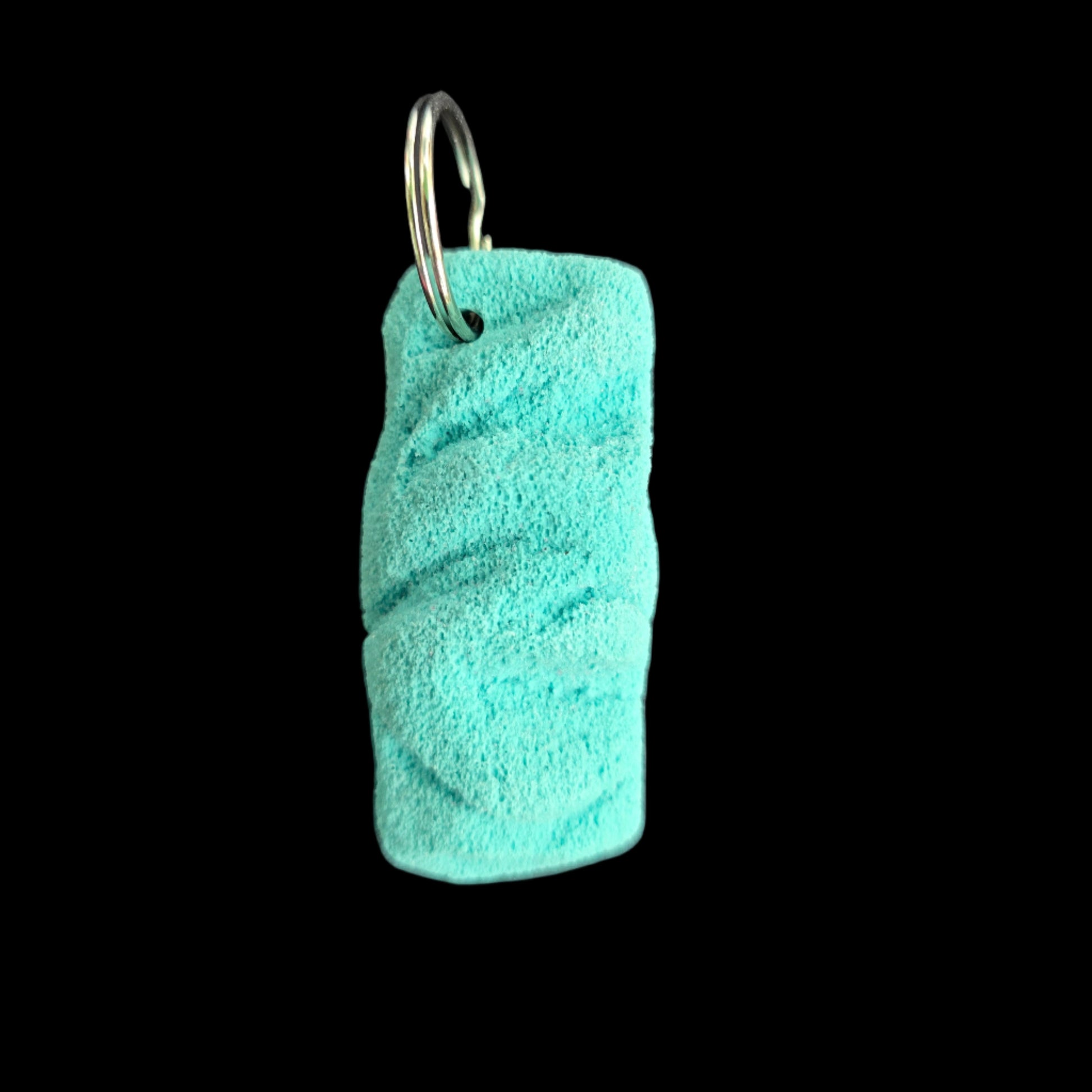 Turquoise colored eroded shape climbing hold keychain