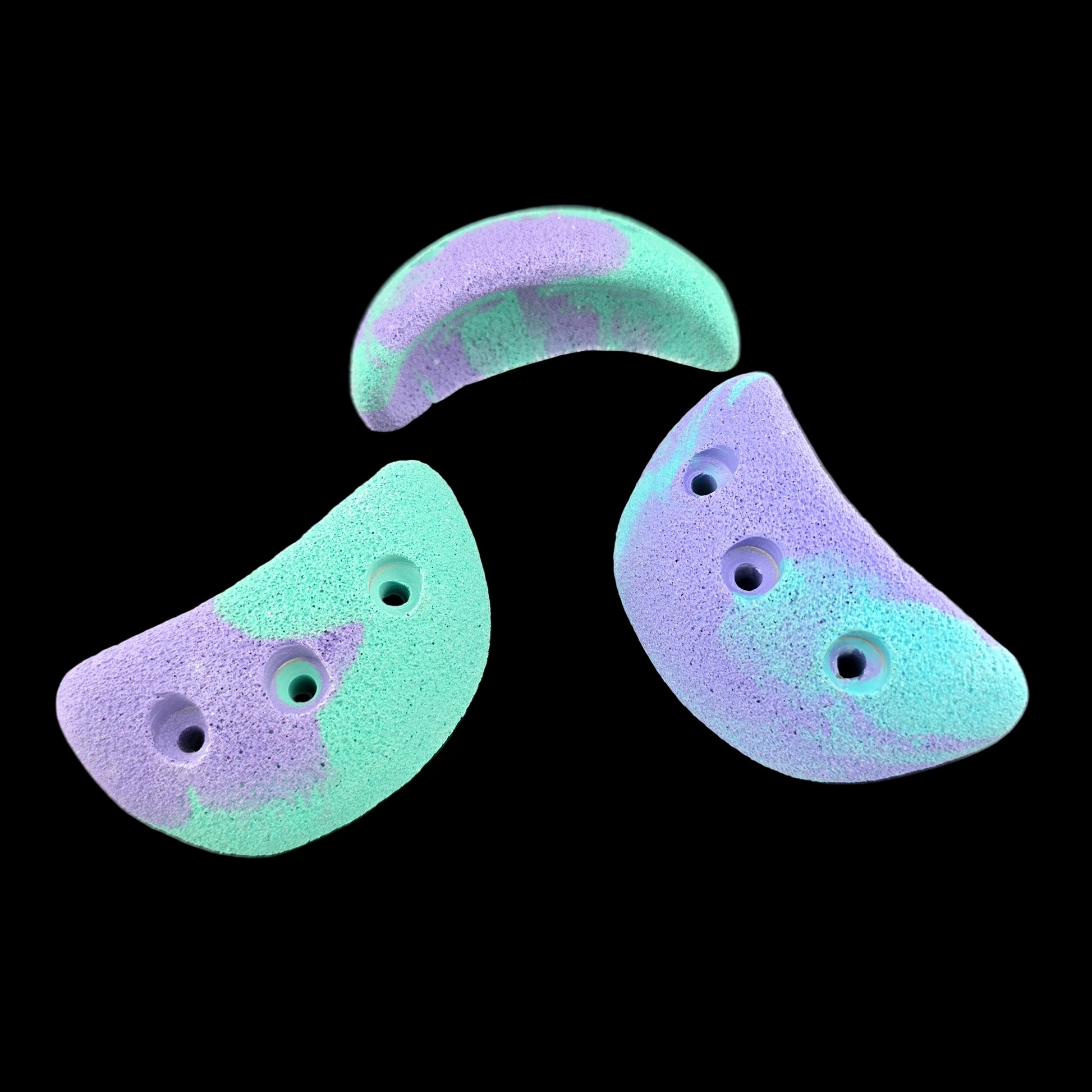 Purple and teal colored jug shaped screw-on climbing holds