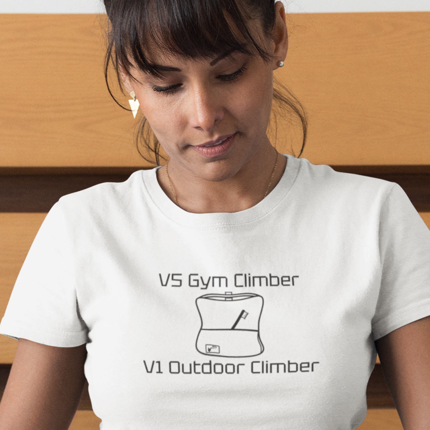 Woman wearing white shirt with black V5 Gym Climber graphic
