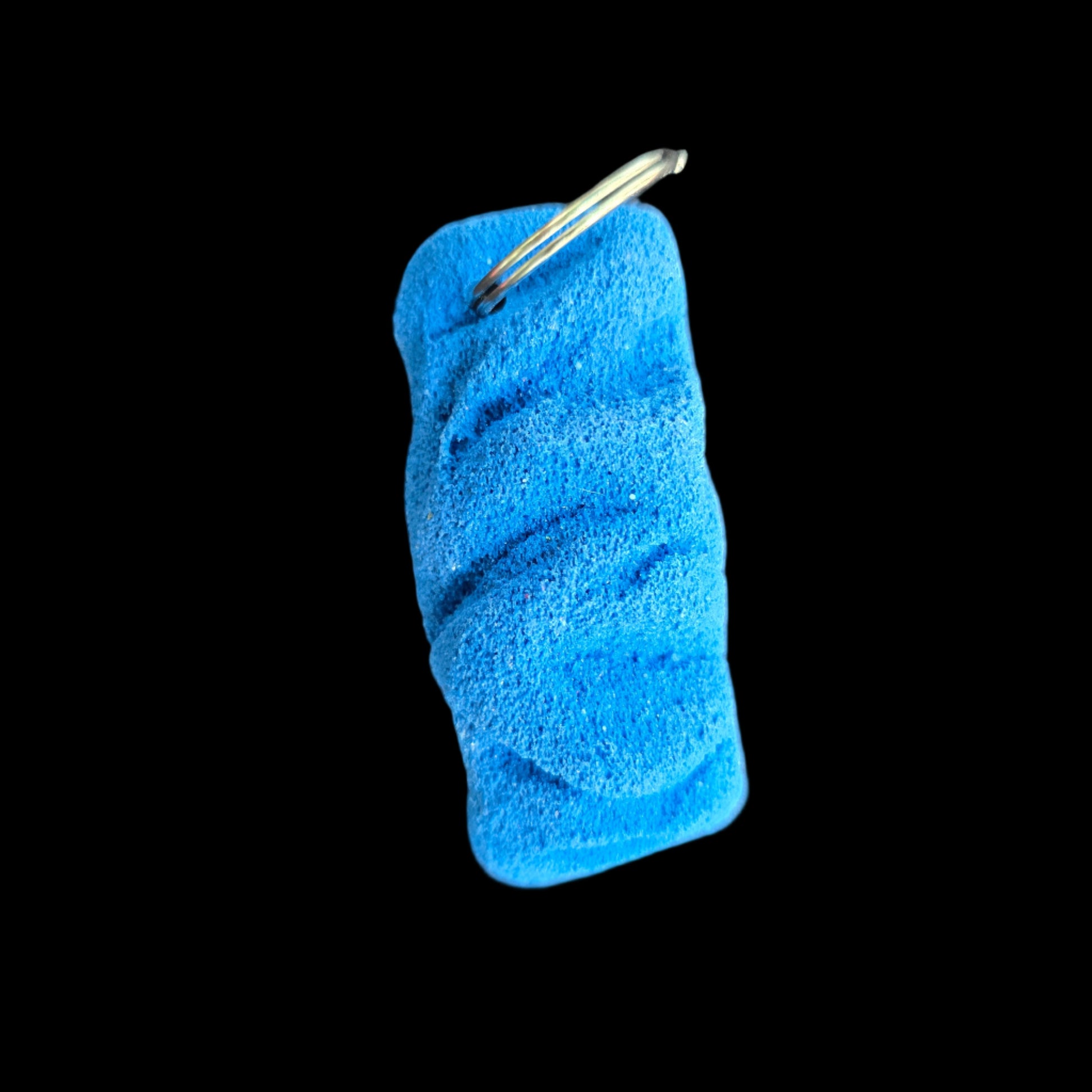 Blue colored eroded shape climbing hold keychain