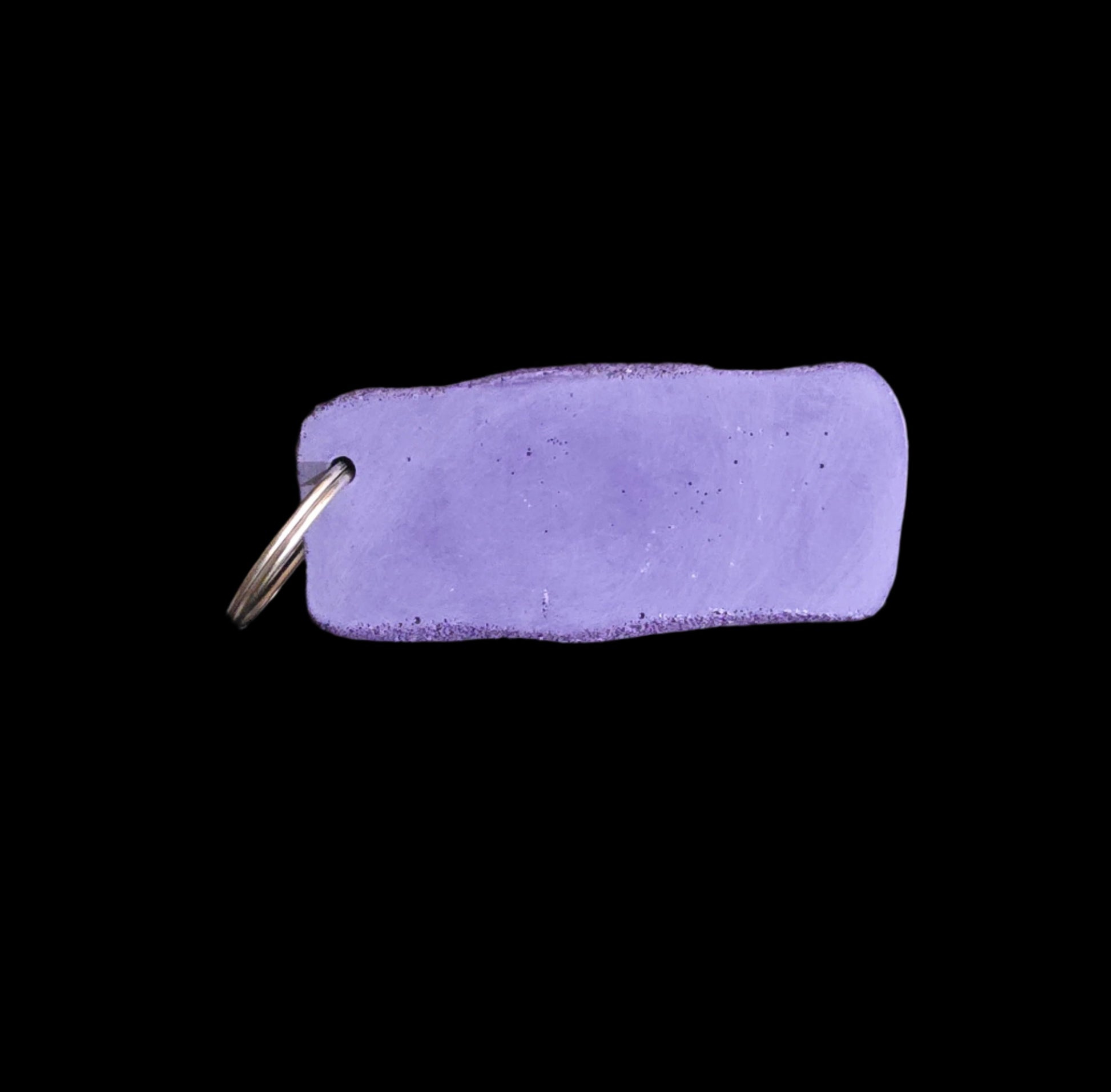Back of purple colored eroded shape climbing hold keychain