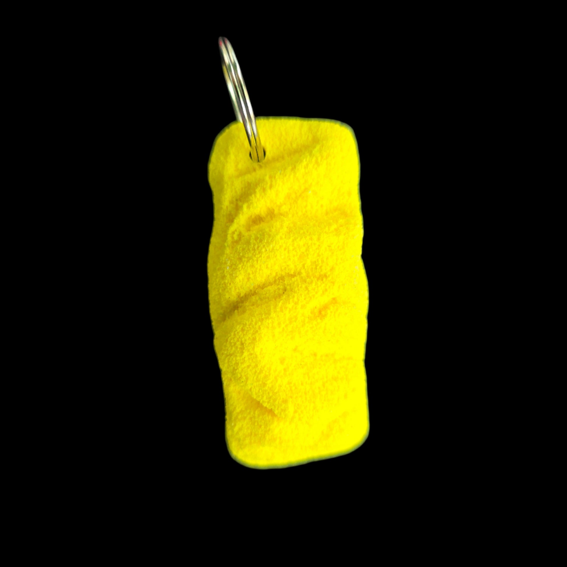 Yellow colored eroded shape climbing hold keychain